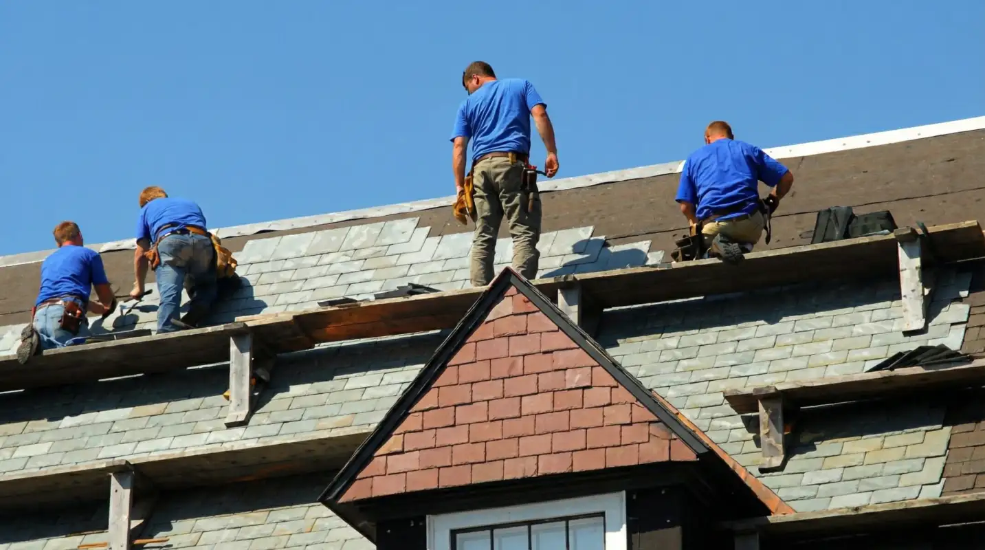 Roof replacement in progress with a team of professional contractors installing new shingles on a residential home in West Palm Beach, FL