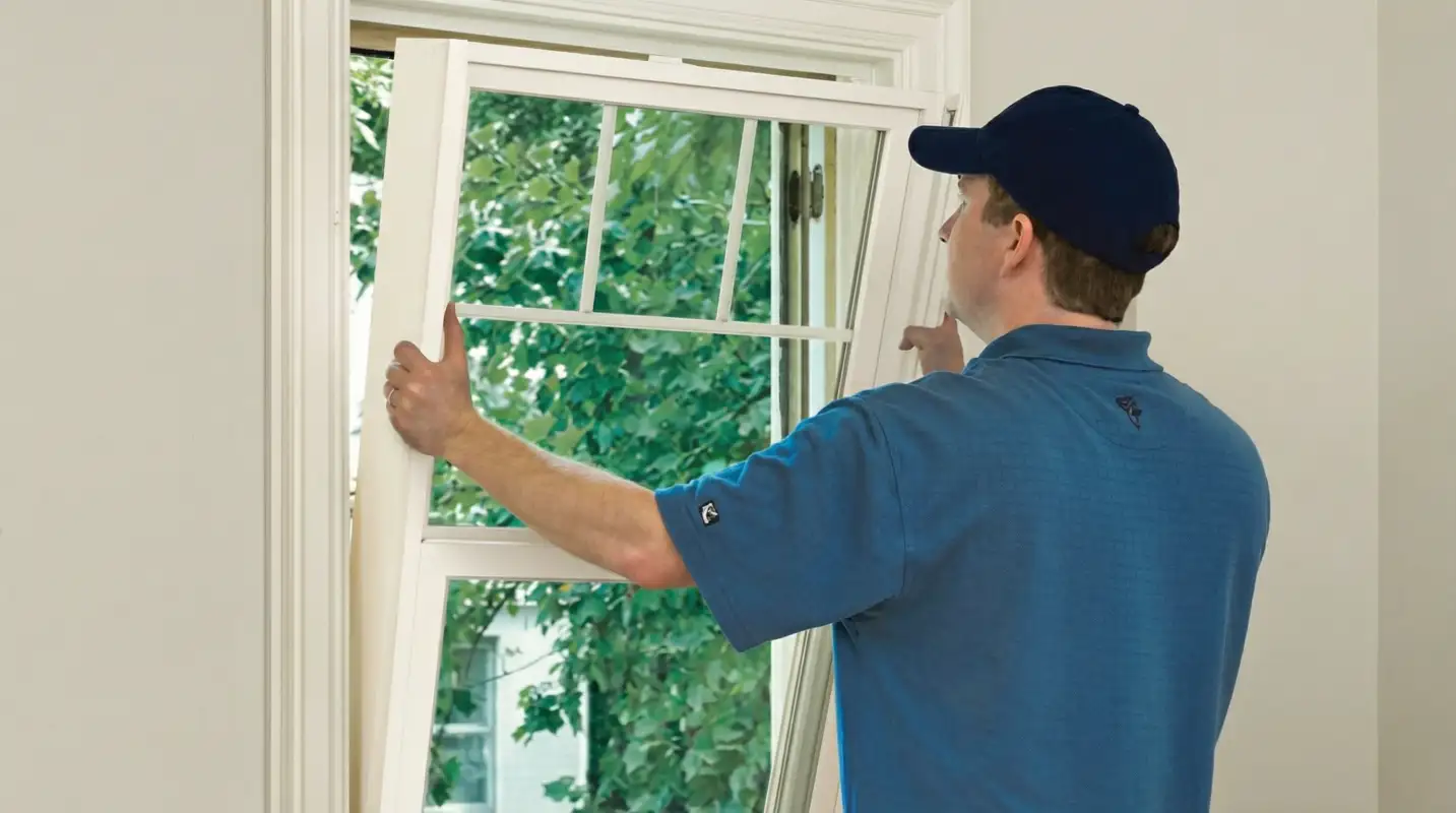 Professional contractors performing a residential window insulation and replacement service in West Palm Beach, FL